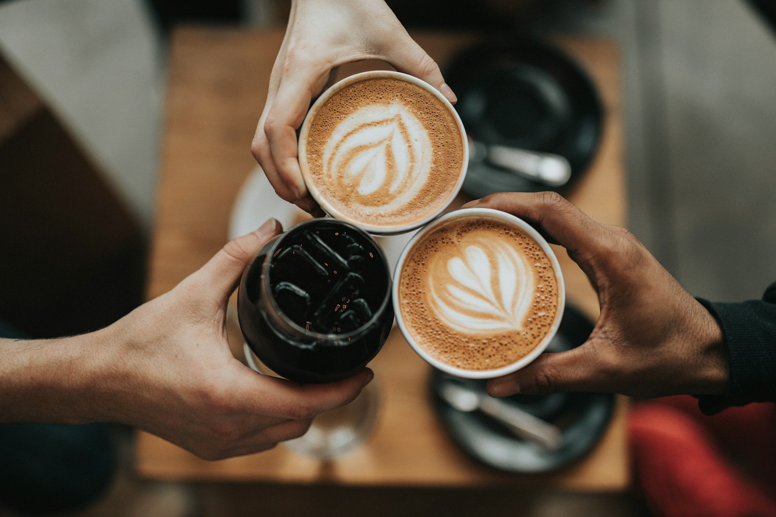 Friends toasting with lattes