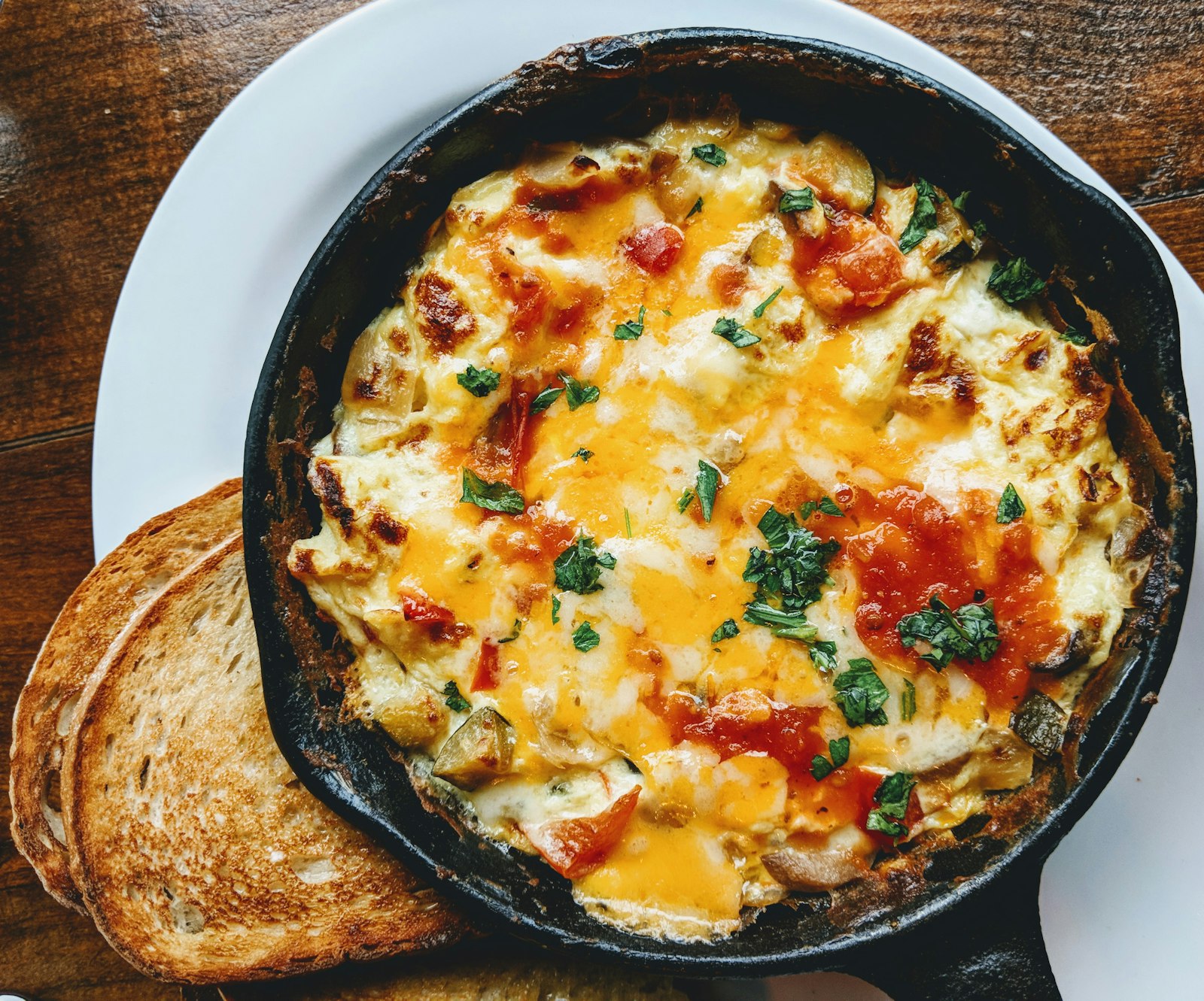 A cheesy cast-iron skillet breakfast with toast
